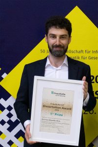 Erion Elmasllari (AUBG '01) holding his ICT Award